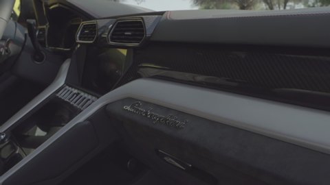Dubai, UAE - ‎December ‎6, ‎2018: Lamborghini interior. Camera from front passenger seat. Accents on logo. 