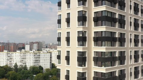 New modern black and white apartment building in the modern metropolis. In summer, aerial view
