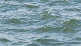 Small waves on the freshwater reservoir of the Dnieper River. Water surface close-up view