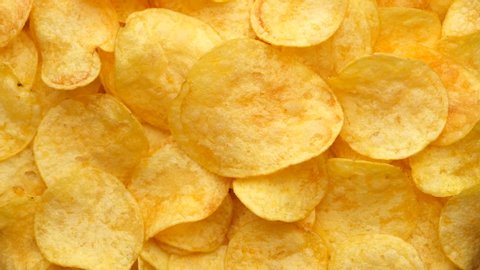 craft potato chips with cheddar cheese, rotating close up