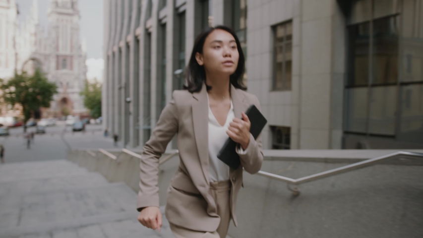 Young asian beautiful businesswomen on hurry walking on stairs look at watch running city female stairway step suit time job smart concept young slow motion Royalty-Free Stock Footage #1057134575