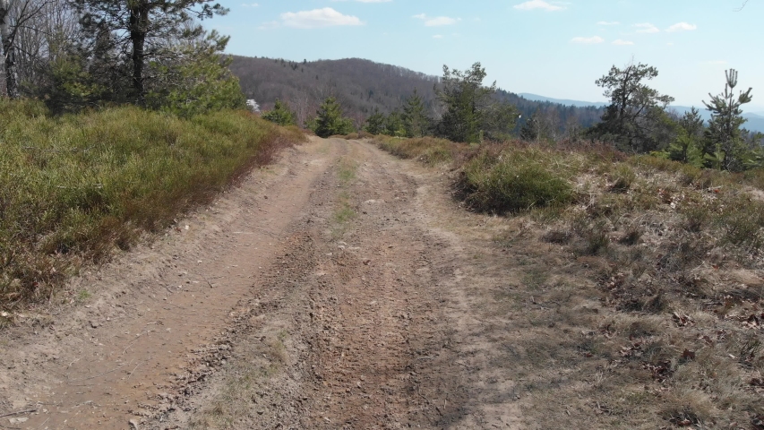 Male walking in Beskid Sadecki Mountains in early spring