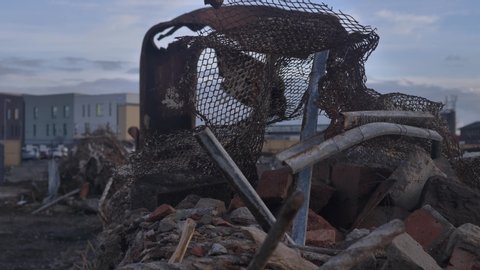 Pan across metal debris from a demolition