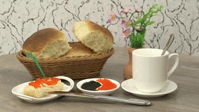 Delicious morning breakfast with white bread and salty caviar with tea cup on wooden table background.