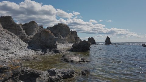 Beautiful Rauk rocks in Gotland island in coastal shot with calm Baltic sea water