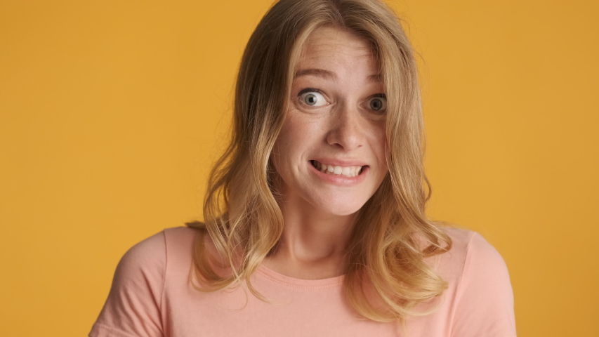 Attractive blond lady guilty looking in camera over colorful background. Oops expression. Sorry | Shutterstock HD Video #1057149170
