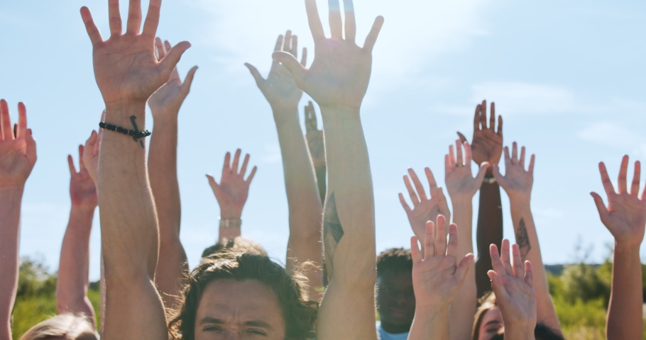 An enthusiastic volunteering organisation concerned about natural environment pollution. The cheerful volunteers, friends putting their hands up to the sky. Wellness, nature protection concept. | Shutterstock HD Video #1057151789