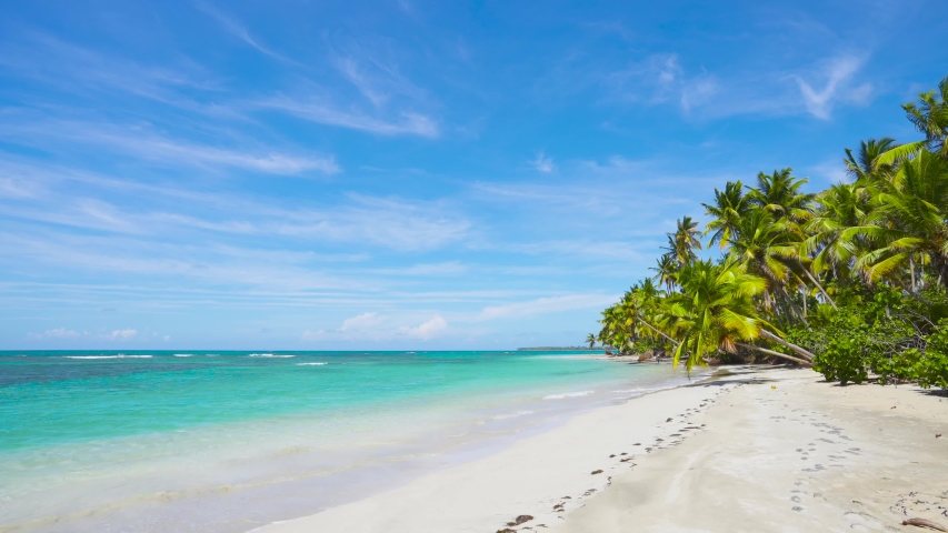Untouched crystal clear sunny white sandy beach background. Sea beach in Dominican Republic. Amazing natural tropical beach background. | Shutterstock HD Video #1057154540