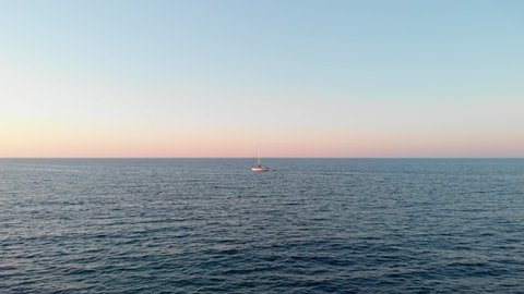 Single boat in sea during sunset by drone Aerial shot