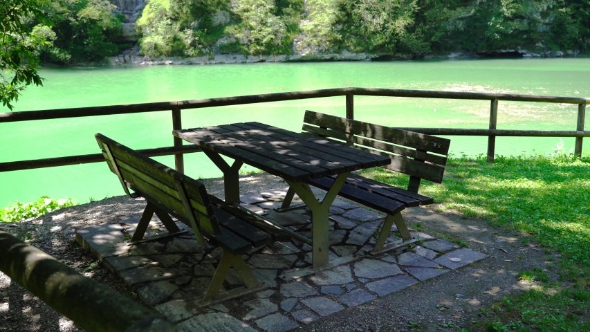 Picnic table in front of the lake in the mountains