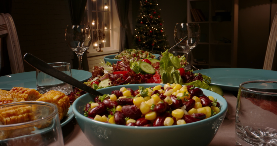 Close up shot of family celebration dinner table served with healthy vegetarian meals. holiday party table during thanksgiving or christmas - food and drink concept 4k footage | Shutterstock HD Video #1057163464