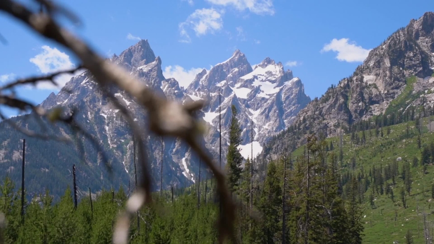 Slow motion reveal shot of the Grand Teton peak.