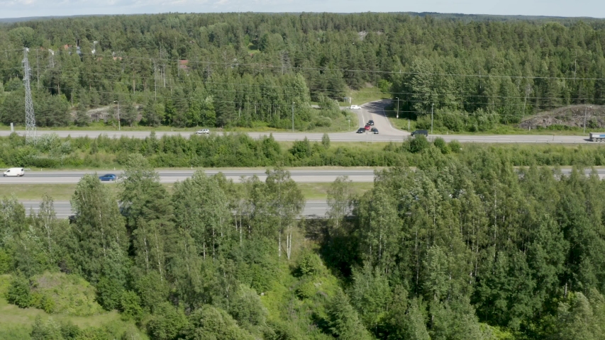 Fast aerial shot following cars driving quickly on a Finnish motorway near Kerava.