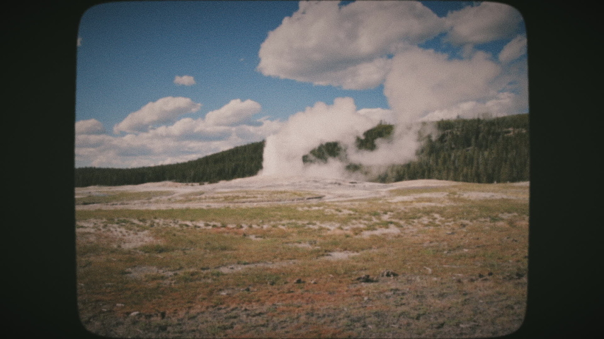Old Faithful Geyser erupting, Yellowstone National Park, Wyoming, USA. Vintage Film Look.