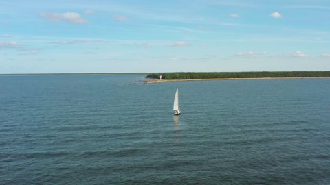 Approaching a sailboat next to an island on a beautiful day
