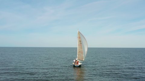 Small sailboat with a large gennaker on the sea