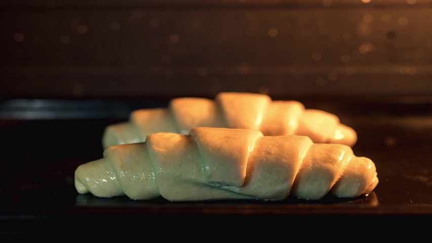 Croissants baking in the oven homemade time-lapse Shot 4K | Shutterstock HD Video #1057176706