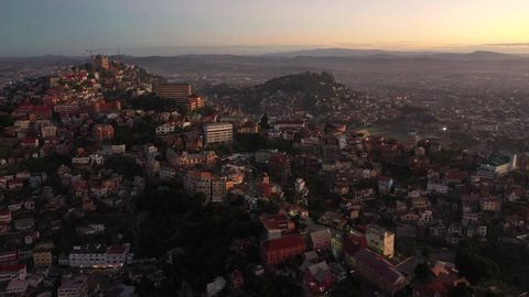 Beautiful view of Antananarivo hills with traditional houses, Haute Ville district and the queen palace called Rova Manjakamiadana, during an epic sunset, travel destination in Madagascar 