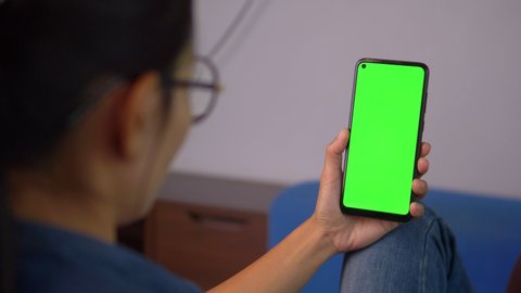 Close-up of female hands using a smart phone. chroma-key, green-screen