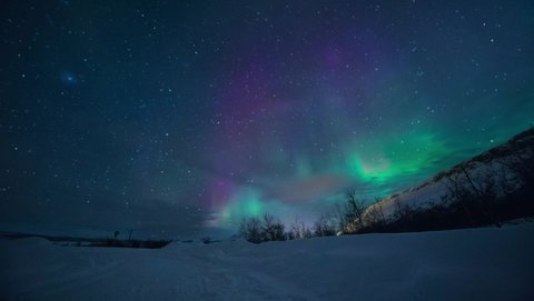 Norther Lights with stars in motion in Norway at night. High quality FullHD footage. Motion background of Northern Lights in night sky.