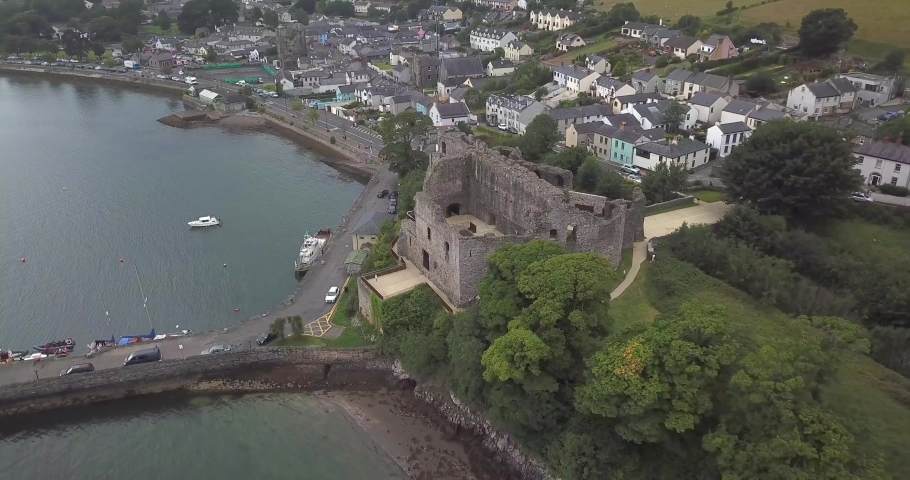 Point of interest drone shot of King John castle with Carlingford town in the background. Ireland, Co. Louth