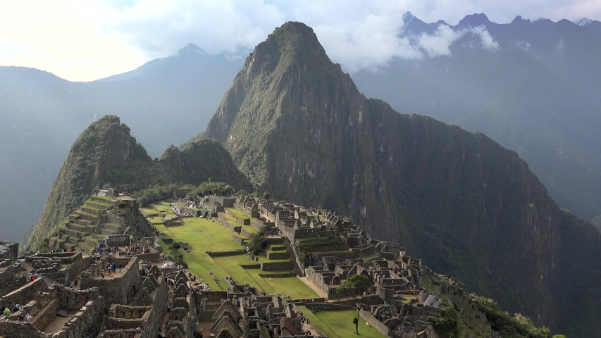 Rainy day at Machu Picchu in Peru, most famous tourist attraction in world, bucket list experience, incredible view of Andes Mountains, static shot