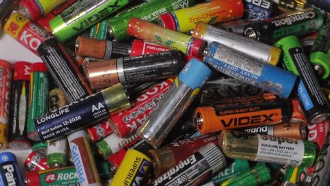 Ternopil, UKRAINE, August 10, 2020: Used batteries, waste, many colored batteries from different manufacturers. Background with batteries