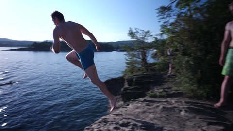 Daring man does a DEATH DIVE into the lake from a cliff