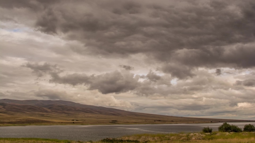 Dillon reservoir in Montana From day to Dark Full HD Time Lapse, going from dusk clouds of a large man-made lake to the headlights of traffic and the stars overhead in Full HD Time Lapse