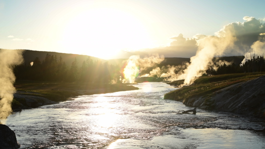 Sunset over Firehole River in Yellowstone National Park Upper Geyser Basin. Great tourist destination in the United States.