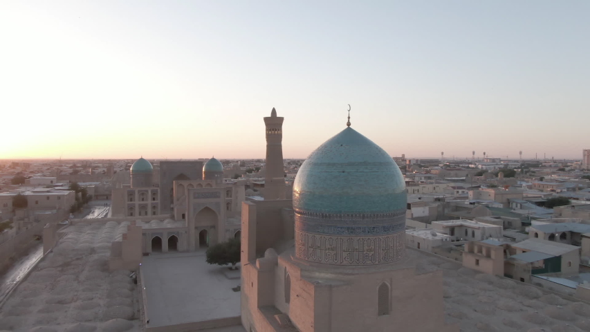 Old Bukhara city (Uzbekistan) panorama in the rays of the setting sun, shot by a drone | Shutterstock HD Video #1057204555