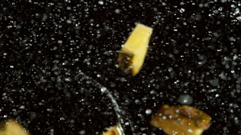 Super slow motion of pineapple slices collision with water splashes. Filmed on high speed cinema camera, 1000 fps.