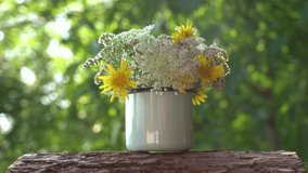 Beautiful floral decorations in vintage rustic style. Bunch of fresh valley flowers isolated on blurry defocused green bokeh background.