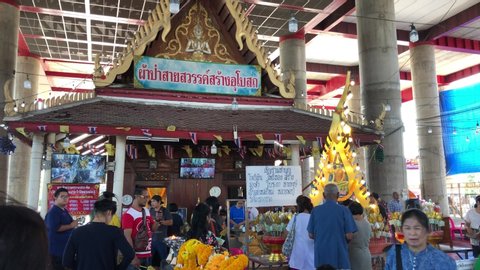 Atmosphere many anonymous people,tourists to worship and pray with holy old buddha statue,this temple is an unseen Thailand with a Buddha wearing sunglasses,Wat Krok krak,Samut Sakhon,Thailand,2020.