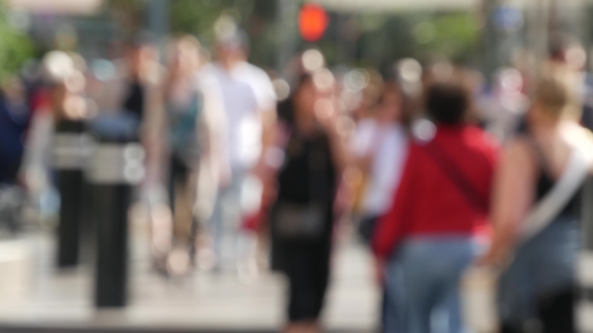 Defocused crowd of people, road intersection crosswalk on The Strip of Las Vegas, USA. Anonymous blurred pedestrians on walkway in crowded urban downtown. Unrecognizable american citizens in sin city. Royalty-Free Stock Footage #1057225504