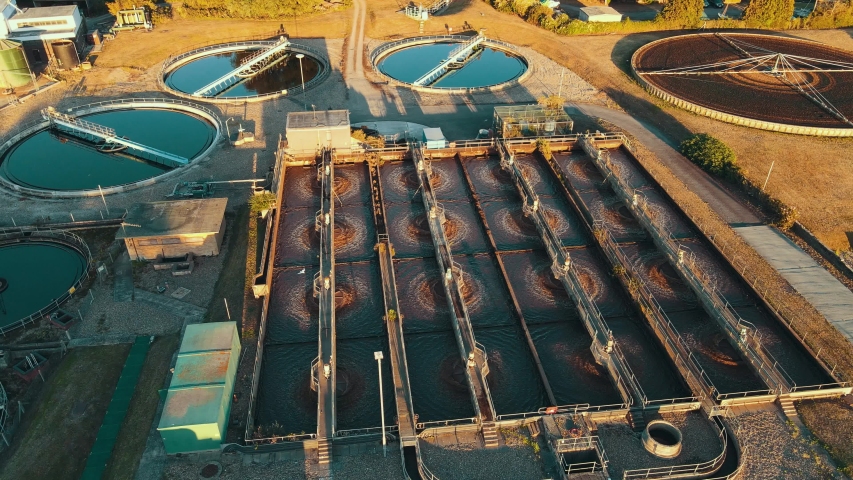 Wide aerial of water purification circle, clean drinking water. Ecosystem of filtration, fresh water and water management. Sewage treatment plant in the sun