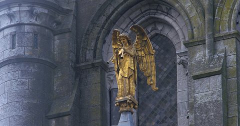 Golden Angel statue two long trumpets to signal Judgement Day St Fin Barr's Cathedral Cork Ireland
