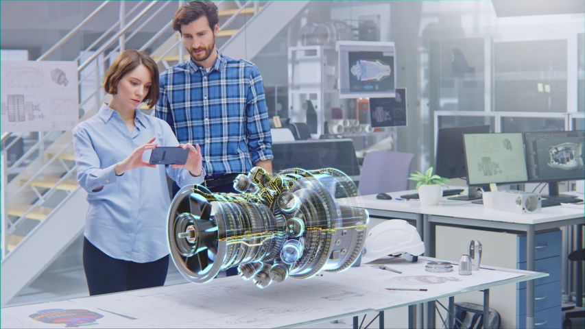 Industry 4.0 Engineering Facility: Female Designer with Engineer Use Smartphone with Augmented Reality App to Manipulate 3D Engine. Specialists Working on Eco-Friendly Green Energy Turbine Concept Royalty-Free Stock Footage #1057229599