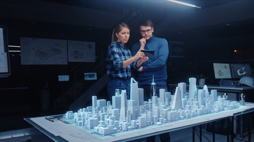 Architect and Engineer have Discussion, Use Augmented Reality Smartphone to Design Sustainable 3D Megalopolis City Model. Futuristic Office with Architectural Designers. Graphical Animation VFX Royalty-Free Stock Footage #1057229623