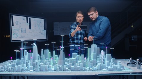 Architect and Engineer have Discussion, Use Augmented Reality Smartphone to Design Sustainable 3D Megalopolis City Model. Futuristic Office with Architectural Designers. Graphical Animation VFX