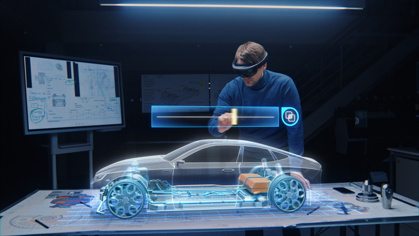 Automotive Engineer Wearing Virtual Reality Headset Working on 3D Electric Car Design, Using Gestures in Augmented Reality He Designs and Manipulates Graphical Parts, Picks Body Color | Shutterstock HD Video #1057229632