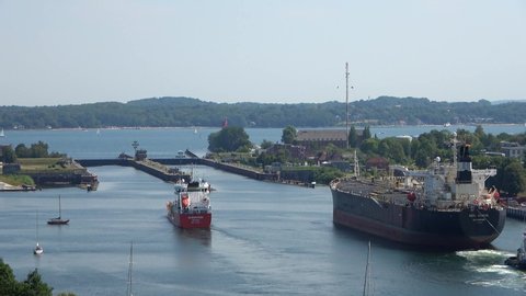 Schleswig-Holstein, Kiel, Germany - August 08 2020: Time Lapse of big and small ships approaching the floodgate at the Kiel Canal