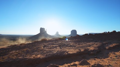Famous red rock formations landscape panoramic view from scenic road trip driving pov in summer in Monument Valley, Arizona North America, USA with butte mesa rocks in morning sunlight sunrise