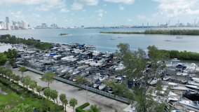 Key Biscayne boat club with Miami port on background, Florida USA. 4K aerial top view on the boat parking at the yacht club. Beautiful slow motion drone video for water sport business