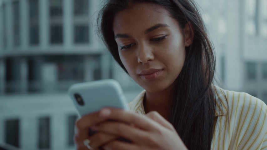 Face beautiful mixed race woman using phone stand serious social media smartphone technology app city streets living urban mobile city slow motion | Shutterstock HD Video #1057244974