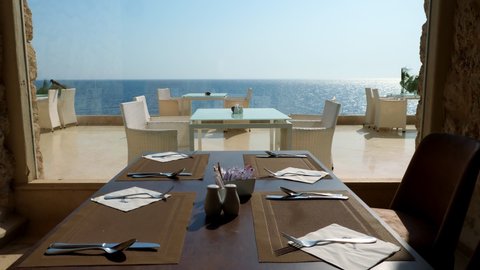 served table in the restaurant by a large panoramic window overlooking the sea.