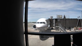Empty boarding area. Dolly POV push in on an airplane outside the window. No travelers at the airport during early days of COVID-19 pandemic - Powered by Shutterstock - Get 15% off with code: PIKWIZARD15