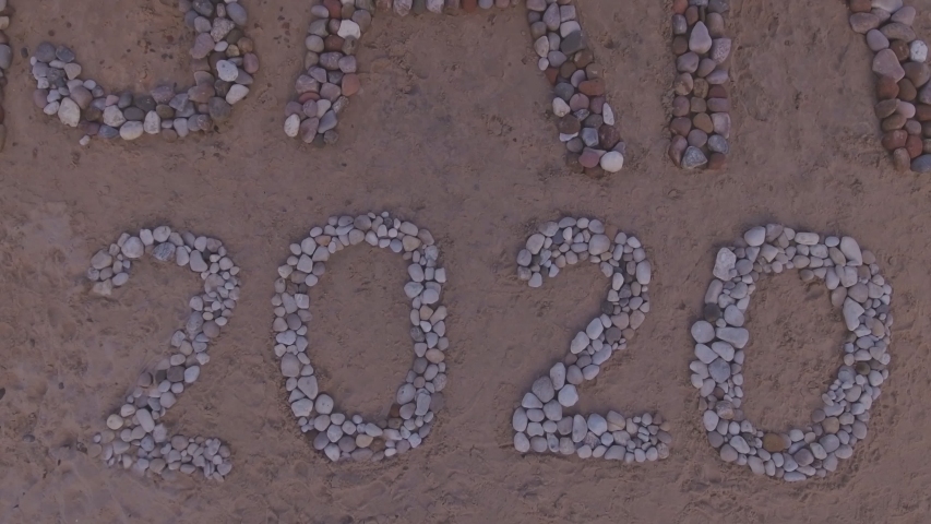 VASARA (Summer) 2020 Inscription and Heart Shape from Stones on the Sandy Beach of the Baltic Sea Coast. Aerial Pedestal-Up Shot | Shutterstock HD Video #1057259158