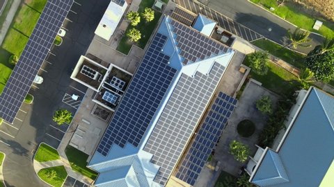 Solar panels on business building. Renewable electric energy. Drone aerial shot 4k. Sustainable building in America.