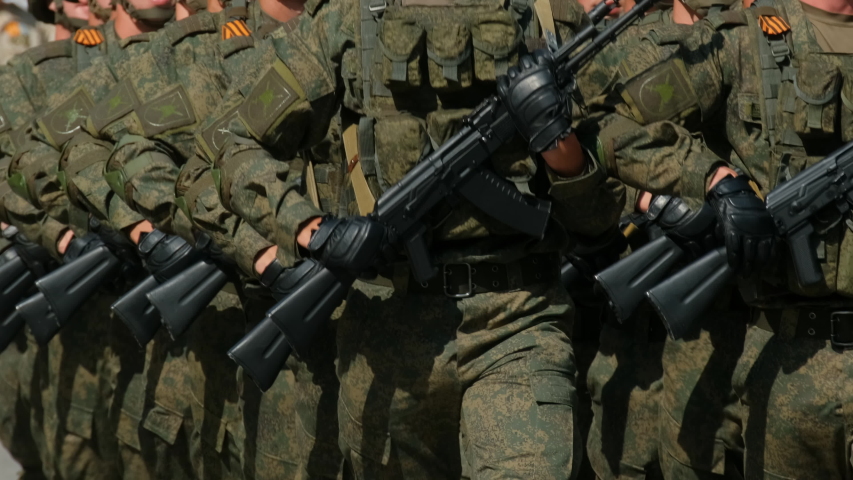 Russian parade military army soldiers assault rifle ak-47 hands march even formation closeup. Officers walk street hold arm kalashnikov firearm. Soldier march show kalashnikov ak 47 close up. Russia.